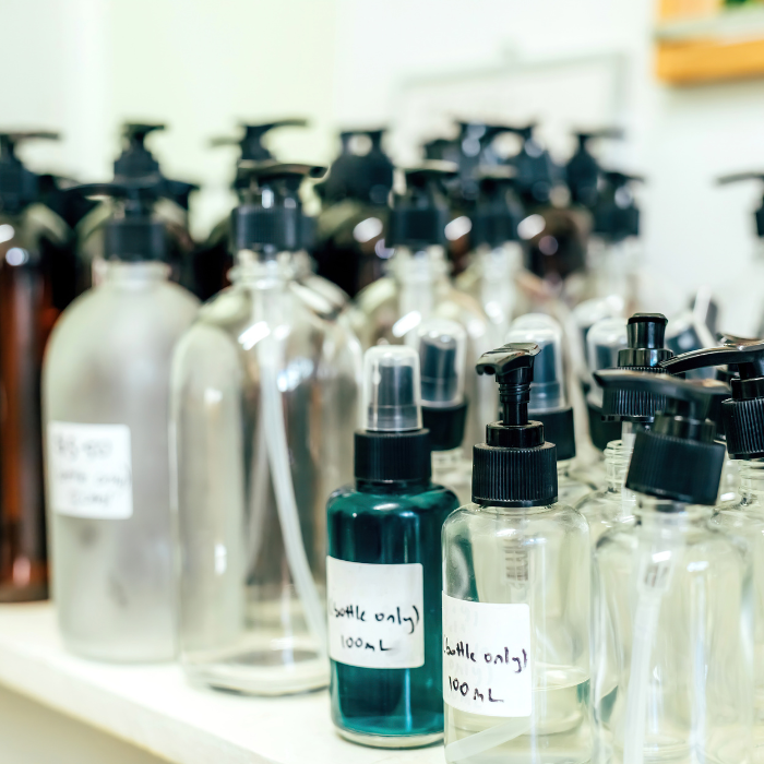 Various spray and pump bottles with hand written labels